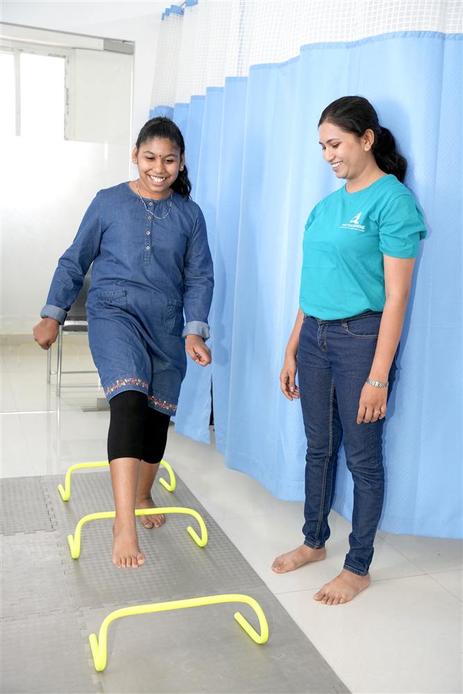 Patient stepping over agility hurdles during guided exercise therapy