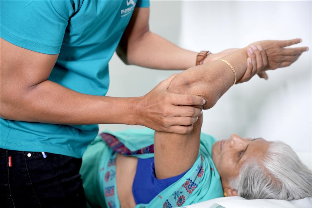 Hands-on shoulder mobilisation on the treatment table at PhysioShine