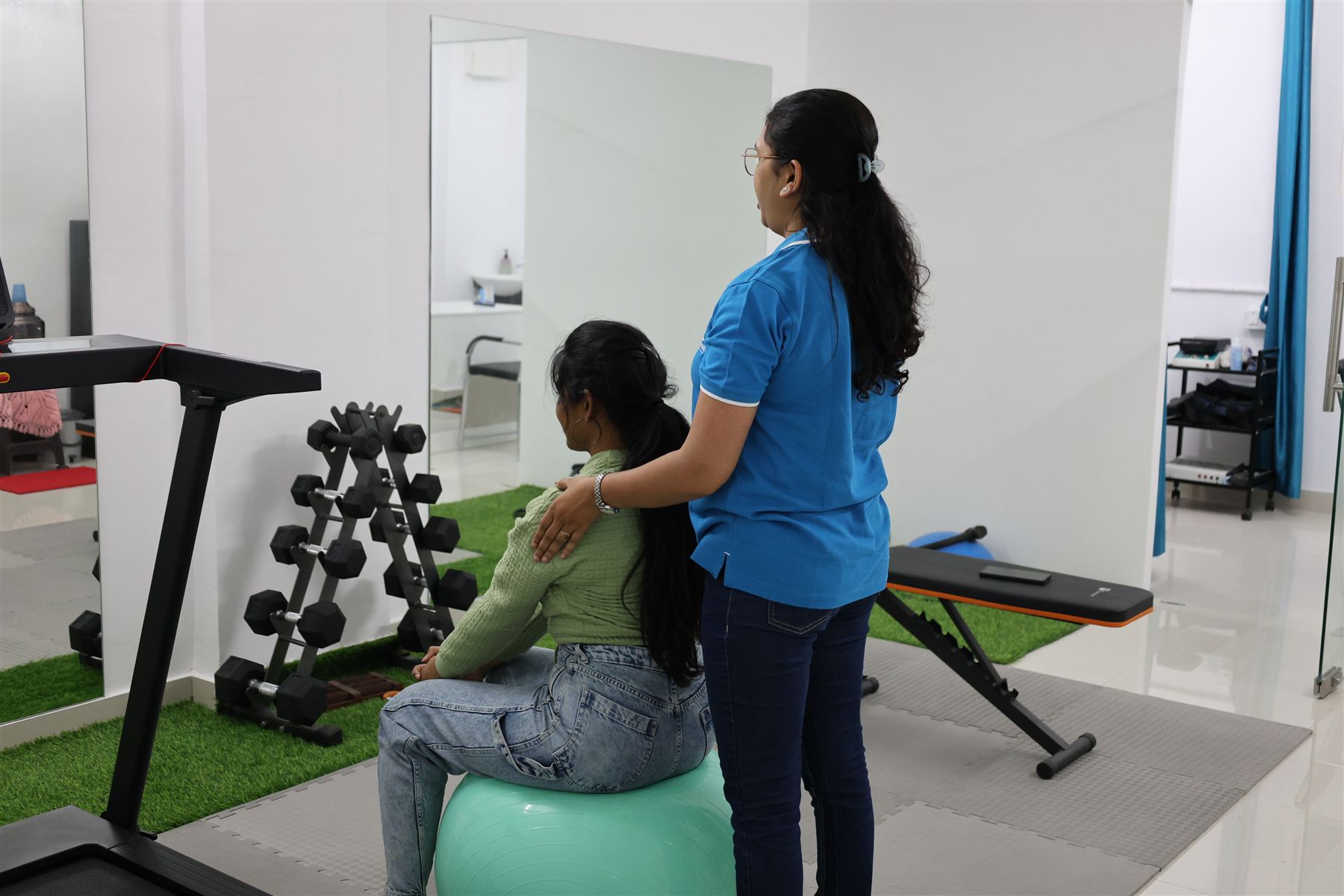 Dr. Mrudula Pawar guiding a patient through Swiss ball exercises in the women's health physiotherapy program